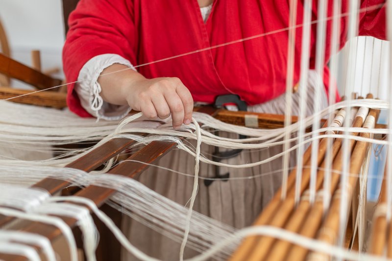 A photo of a weaver weaving textiles for the Bray School.