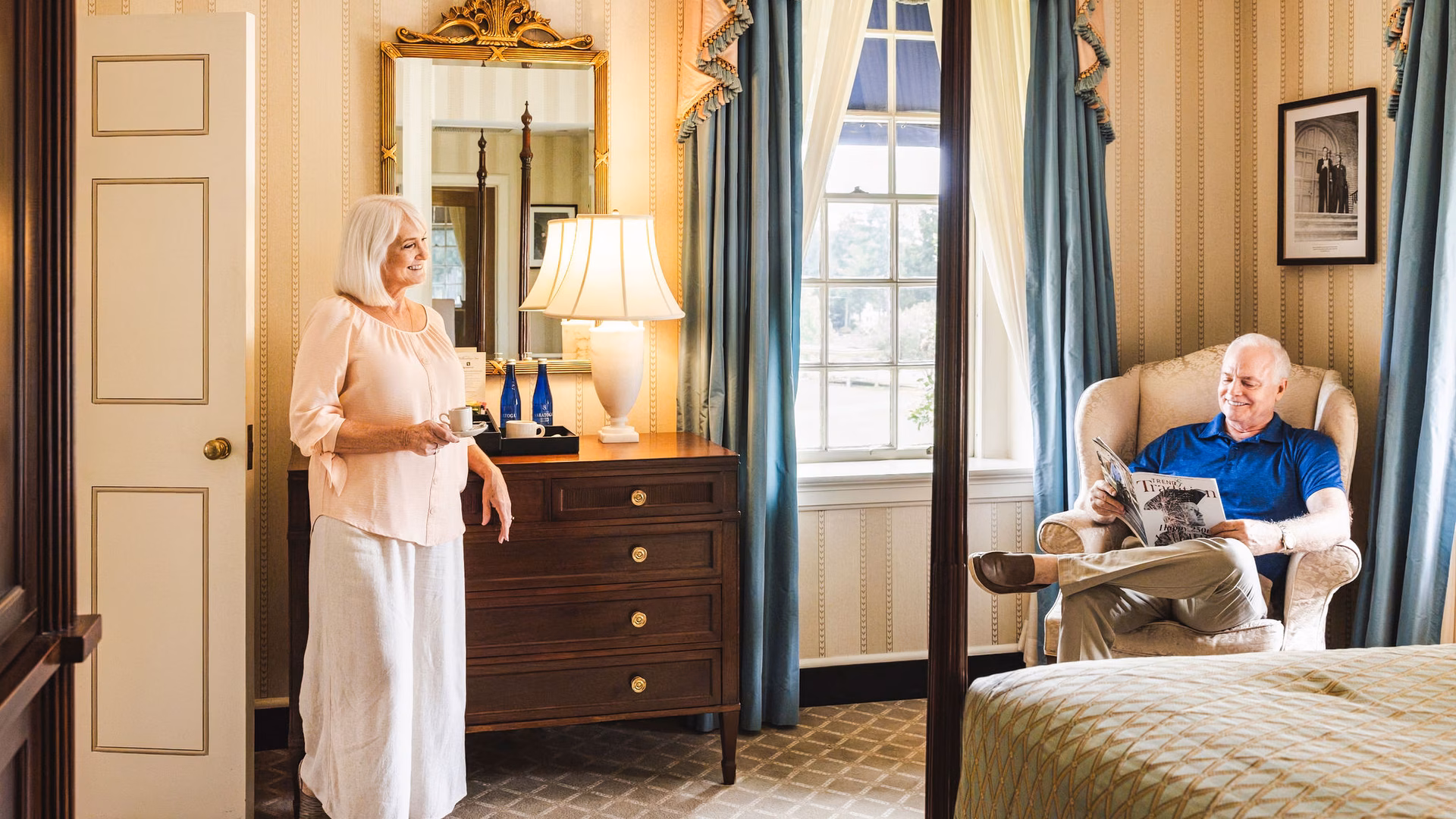A couple sitting in a hotel room