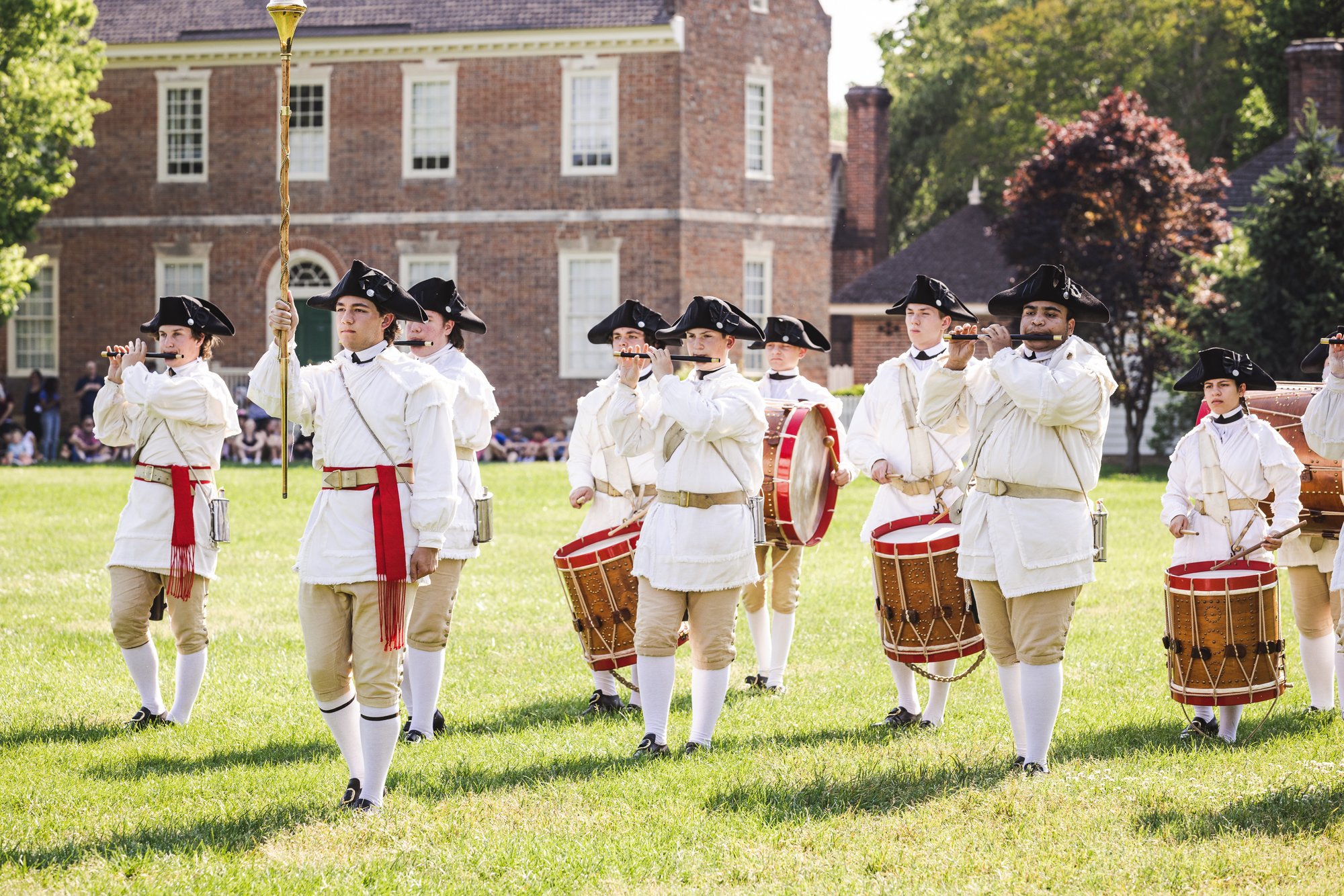 A photo of Colonial Williamsburg's Fife and Drum Corps on Market Square green.