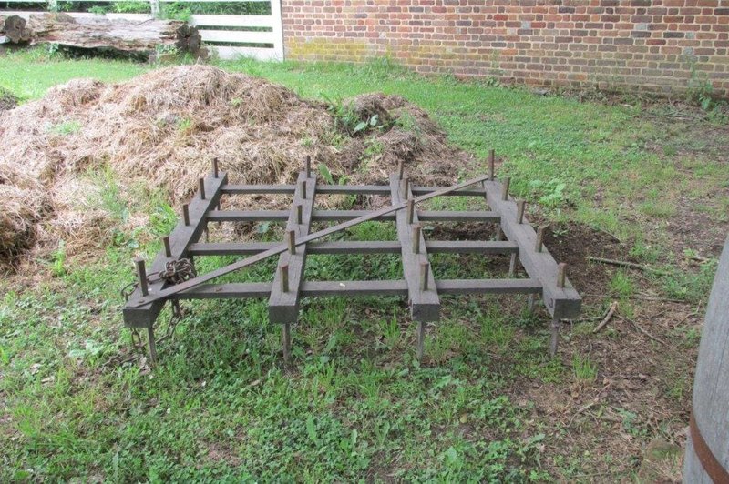 A photo of a replica harrow, an 18th-century tool for plowing fields.