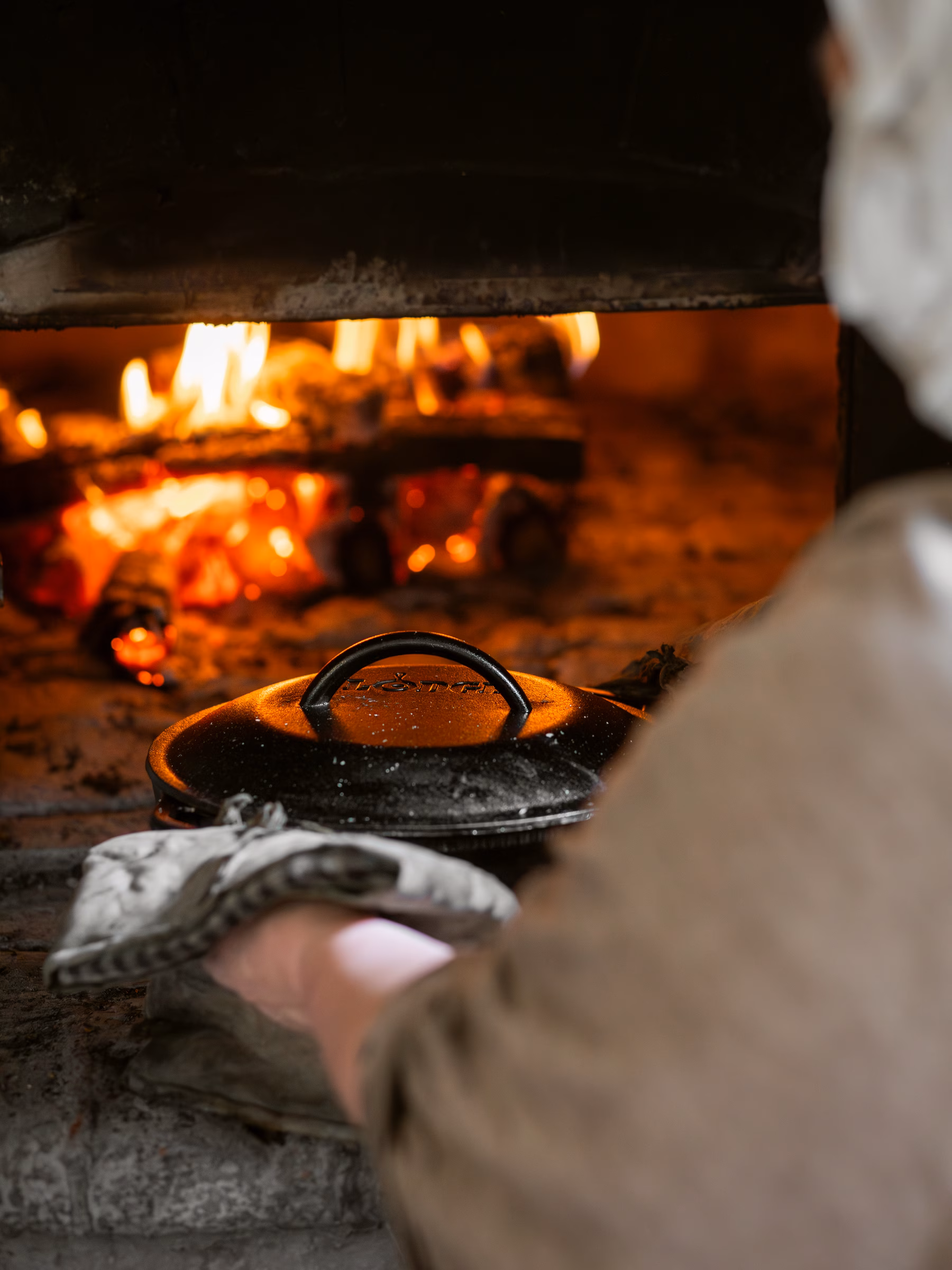 Putting bread in the oven to bake at Raleigh Tavern