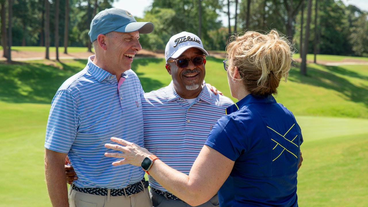 Rhonda Khabir, Keith Jackson, and John Kueser enjoy the festivities at the opening of The Shoe