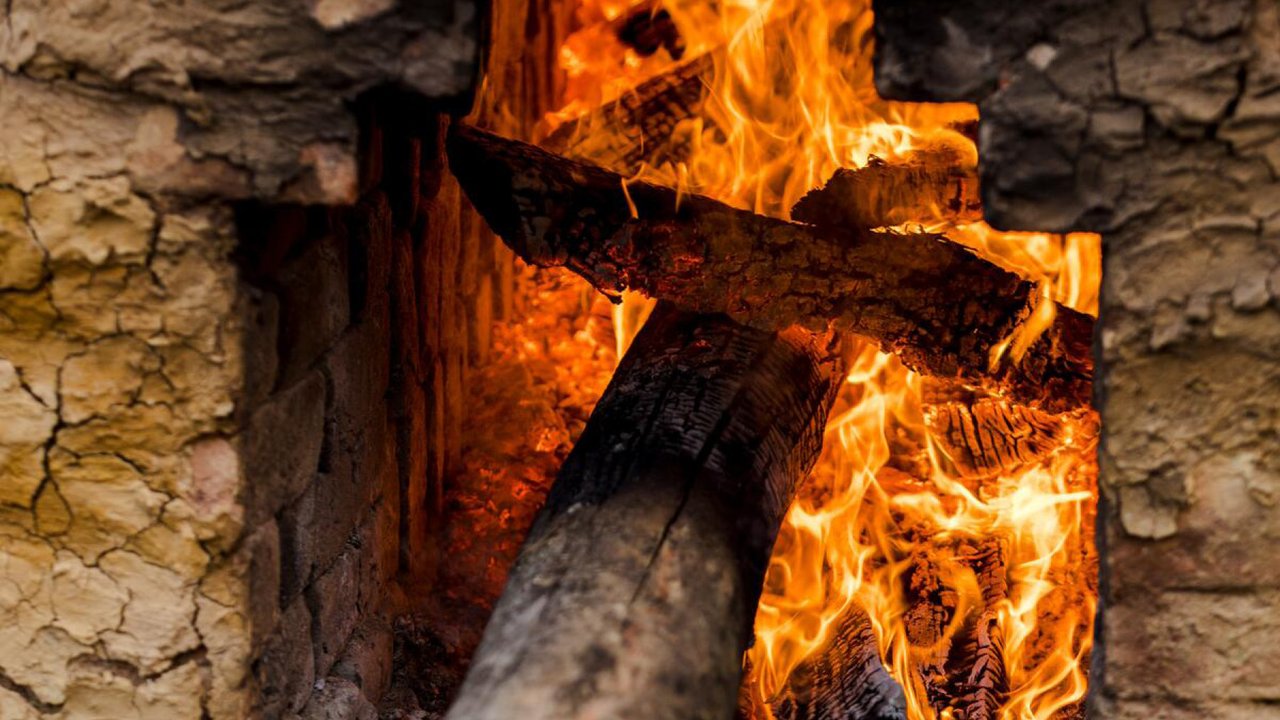 A fire burns in an open kiln