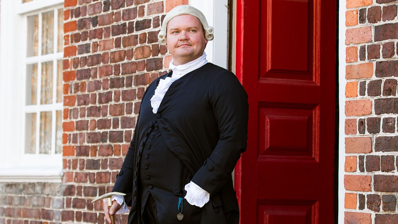 An interpreter dressed as George Wythe faces the camera.