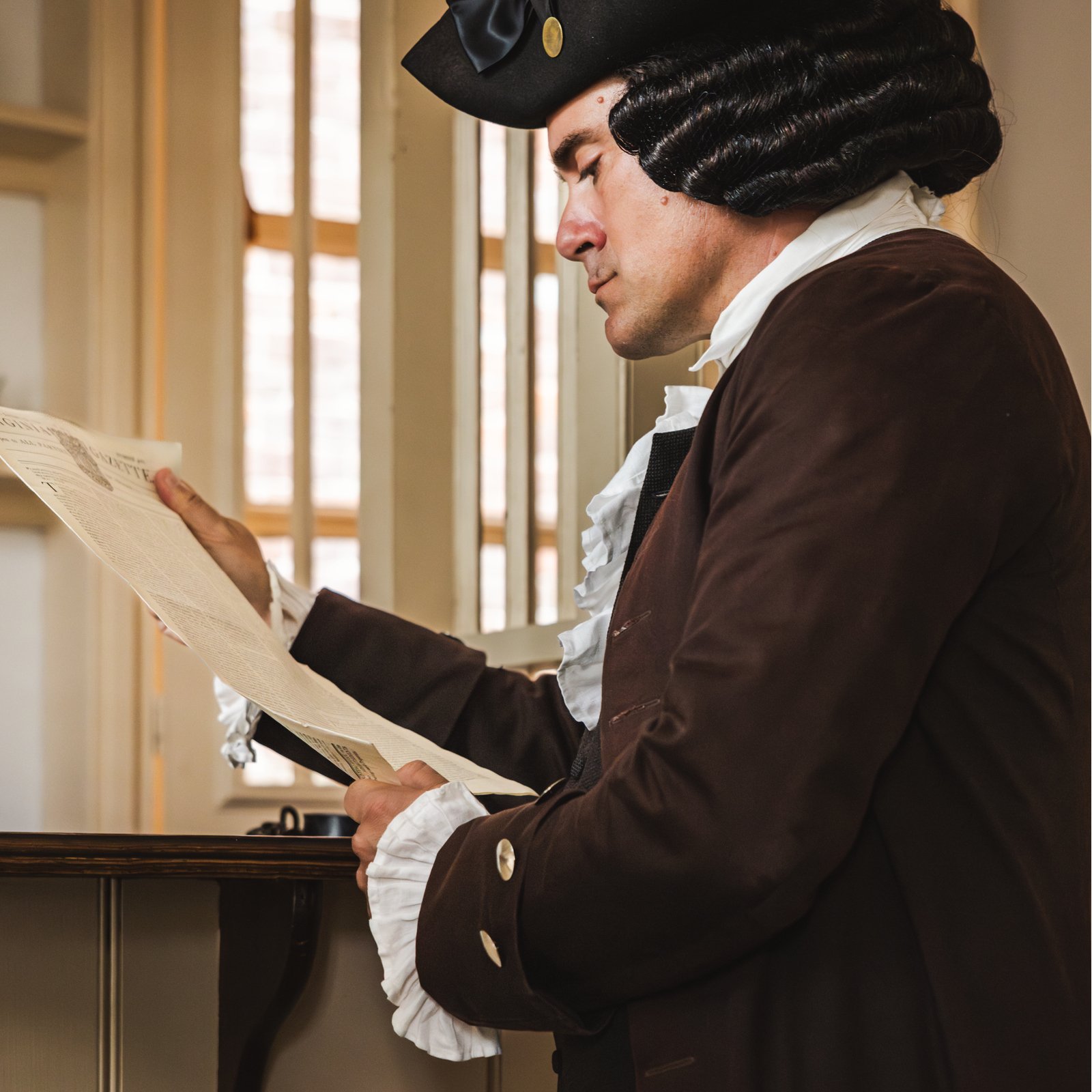 Nation Builder Patrick Henry reviews a document.