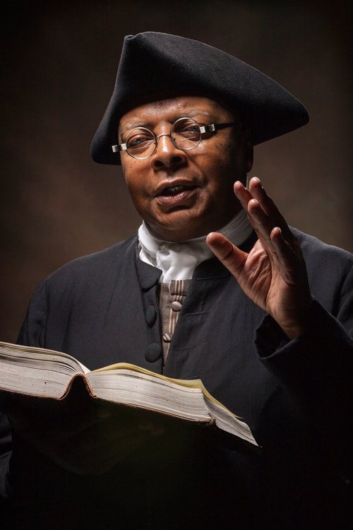 An interpreter dressed as Gowan Pamphlet reads from the Bible.