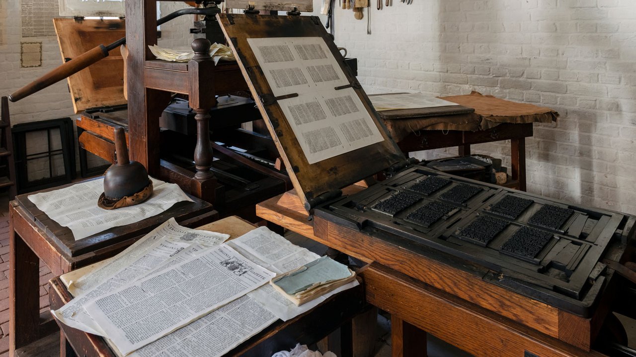 Virginia Gazettes sit on the printing press in the Colonial Williamsburg Print Shop.