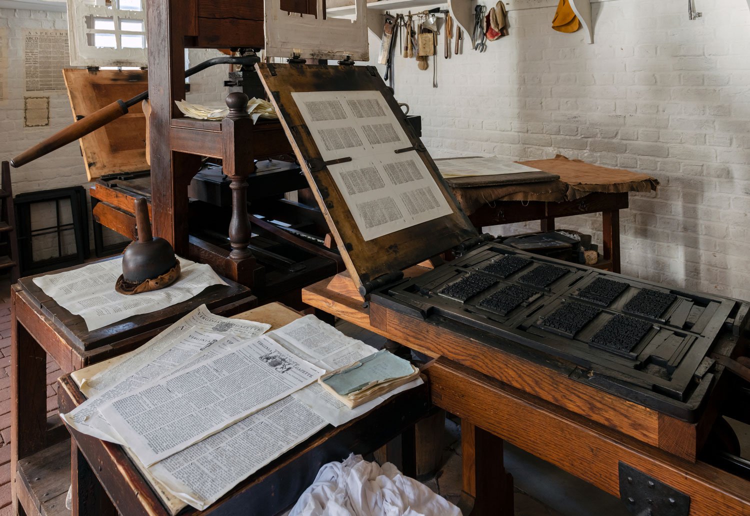 Virginia Gazettes sit on the printing press in the Colonial Williamsburg Print Shop.